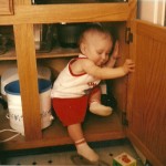 Chris playing in the cupboard