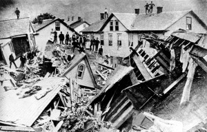 People stand atop houses among ruins after flooding in Johnstown, Pa., May 30, 1889. (AP Photo)